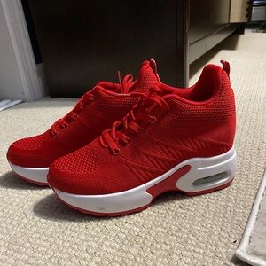 Red hidden wedge sneakers.